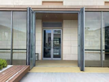 Tall glazed bi-folding door panels stacked at both sides of a broad opening