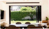 FD-95 folding doors open a dining and living space to a garden