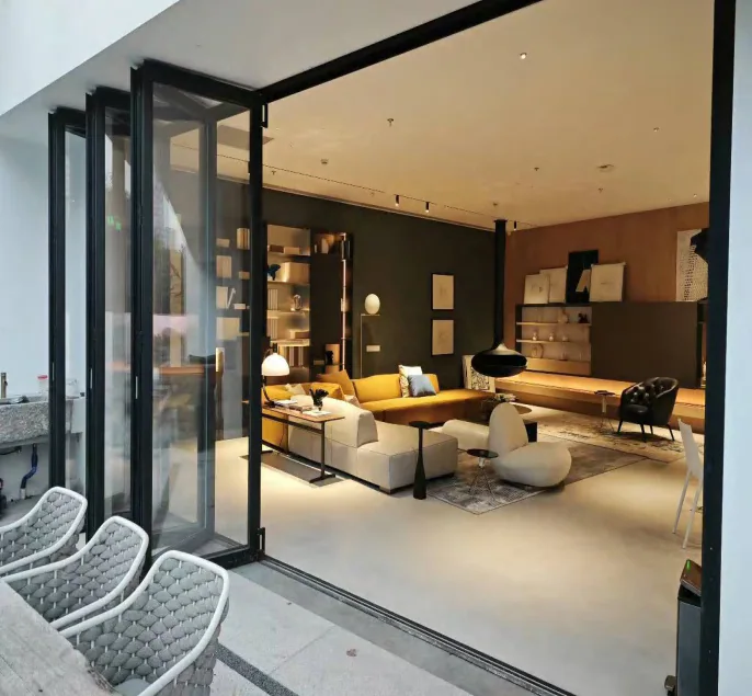 The same living space with bi-folding panels stacked to open the room to the terrace