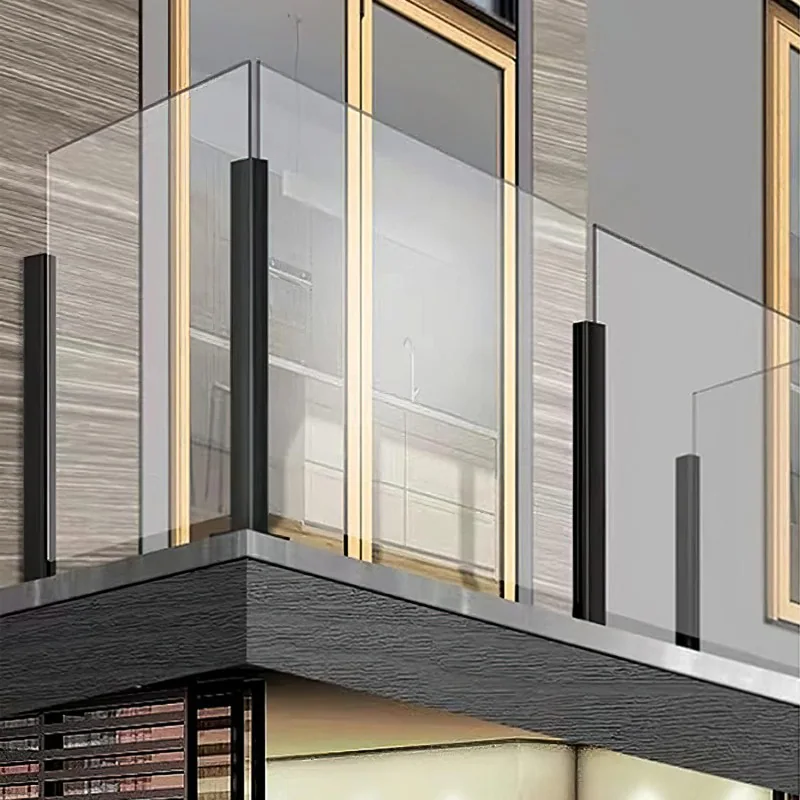 Clear glass balcony supported by black railing posts against a modern architectural facade